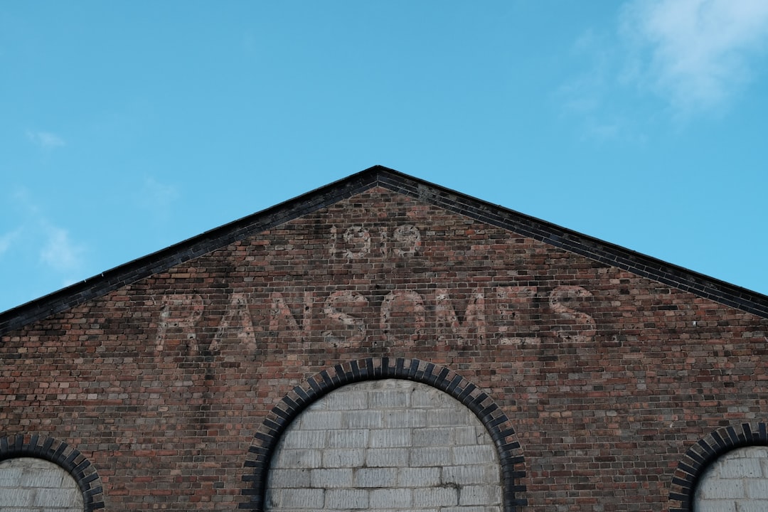 Ipswich, Suffolk: a brick building with two arched windows and graffiti on the side