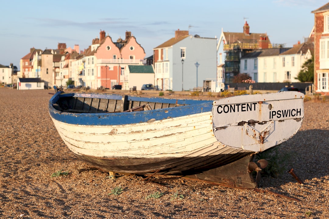 Lowestoft, Suffolk: white and blue boat on sea shore